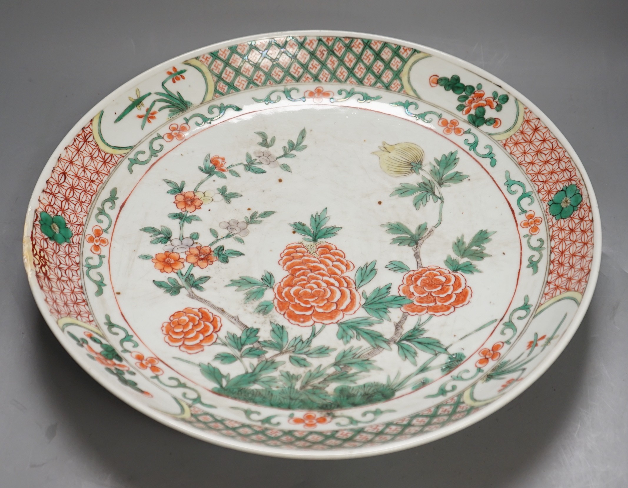 A large 19th century Chinese famille verte peony and dragon dish, 38.5cms diameter